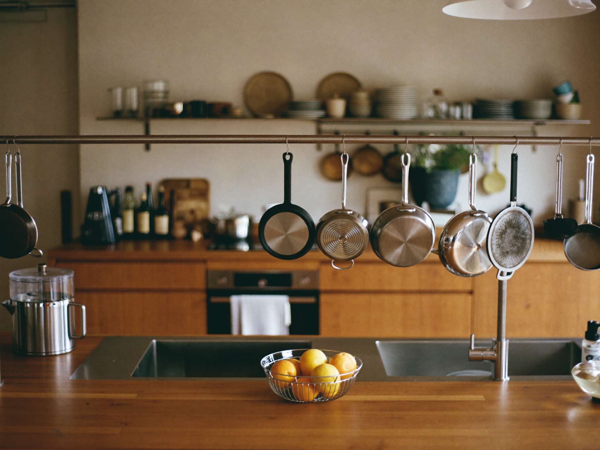 Stocked co-living kitchen with cookware, dishes, and full-size appliances